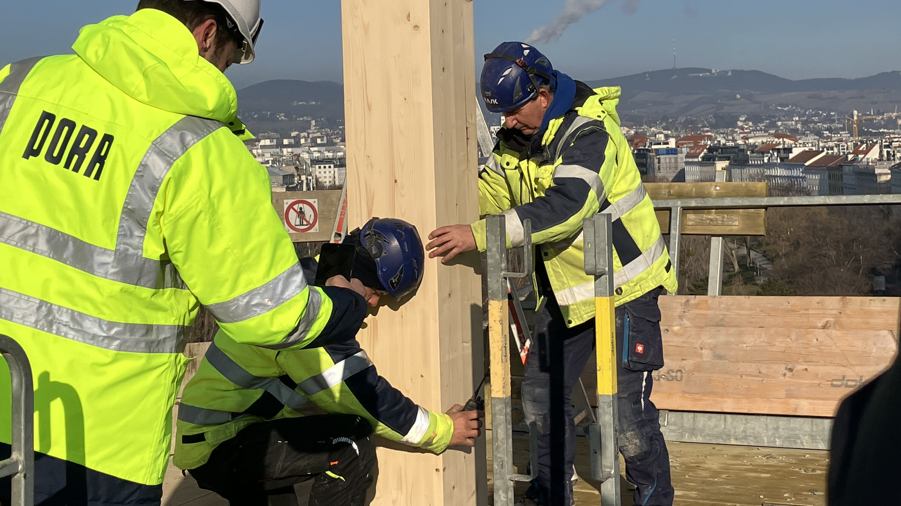 Workers assemble the last wooden support